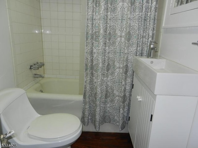 full bathroom featuring vanity, toilet, wood finished floors, and shower / tub combo