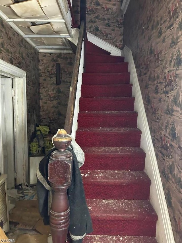 staircase featuring wallpapered walls