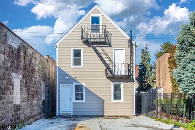 rear view of property with fence