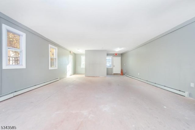 spare room with a baseboard heating unit, concrete flooring, and a baseboard radiator