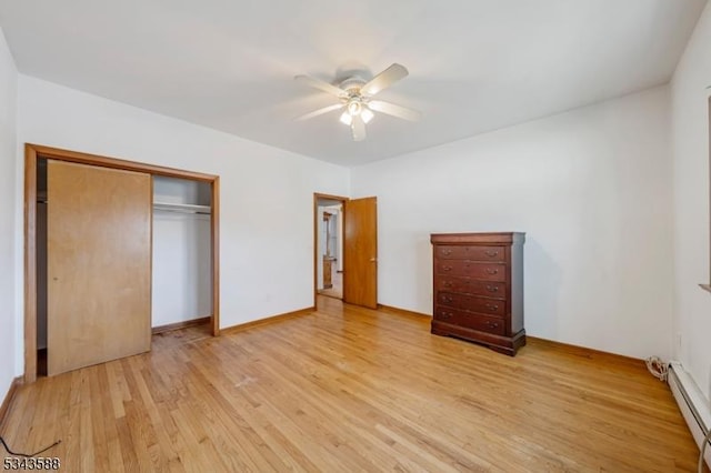 unfurnished bedroom with a closet, light wood-style flooring, ceiling fan, and a baseboard radiator