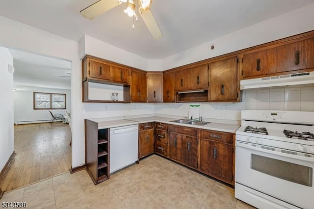 kitchen with under cabinet range hood, open shelves, white appliances, and a sink