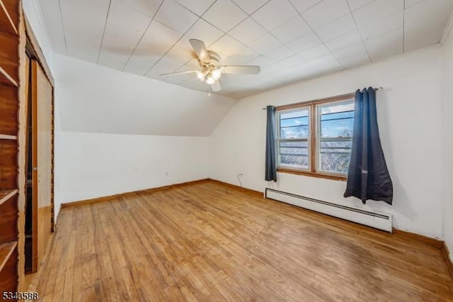 bonus room featuring a ceiling fan, wood finished floors, baseboards, lofted ceiling, and baseboard heating