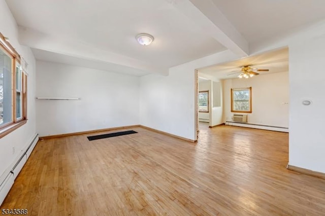 unfurnished room with beamed ceiling, wood finished floors, and a baseboard radiator