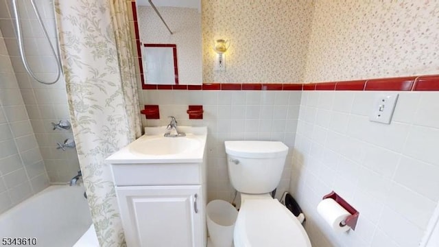 full bath with wainscoting, wallpapered walls, vanity, and shower / bathtub combination with curtain