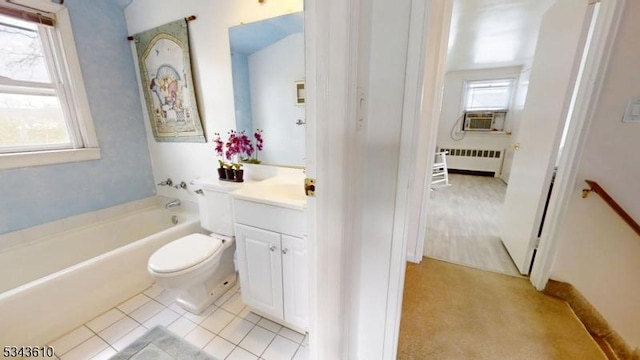 bathroom featuring toilet, radiator heating unit, tile patterned flooring, a bath, and vanity