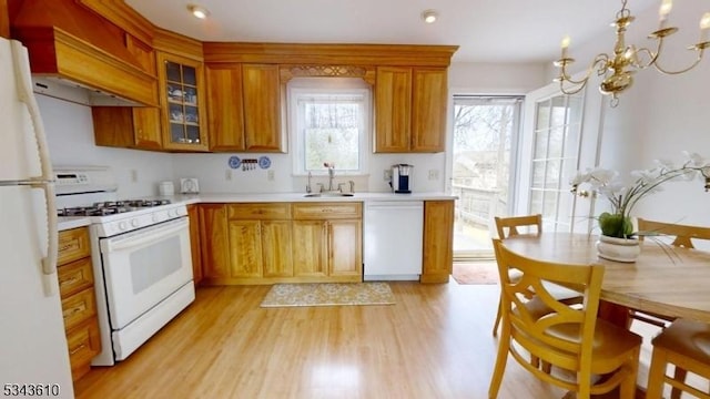 kitchen featuring premium range hood, light wood-style flooring, a sink, white appliances, and light countertops