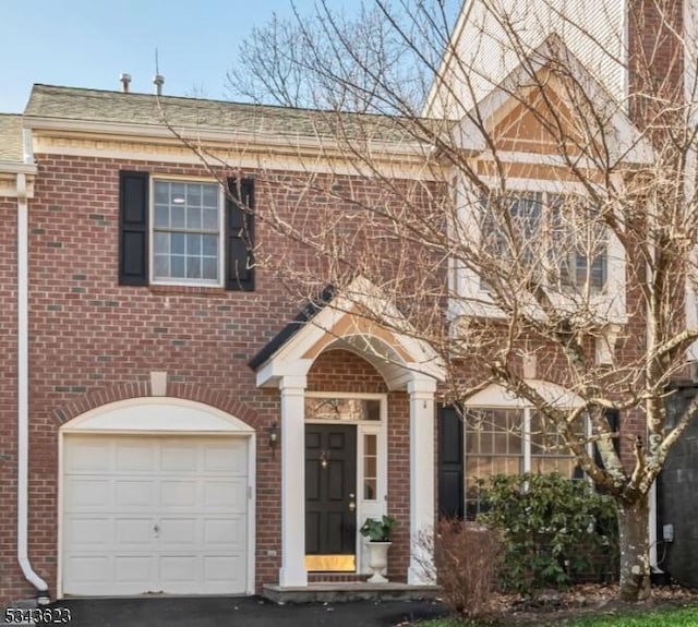 view of front of property with brick siding and an attached garage