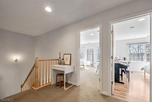 hallway with an upstairs landing, recessed lighting, and baseboards