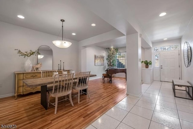 dining room with light wood finished floors, recessed lighting, and baseboards