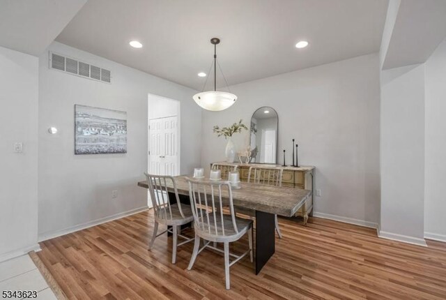 dining space featuring recessed lighting, visible vents, and wood finished floors