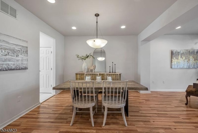 dining space featuring visible vents, recessed lighting, and wood finished floors