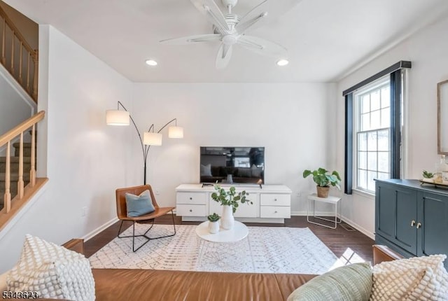 living room featuring dark wood finished floors, recessed lighting, baseboards, ceiling fan, and stairs