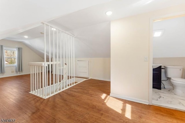 additional living space with vaulted ceiling, recessed lighting, wood finished floors, and baseboards