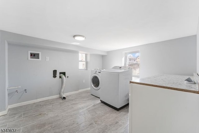 clothes washing area featuring washer / dryer, baseboards, and laundry area