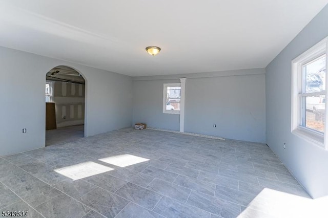 spare room with arched walkways