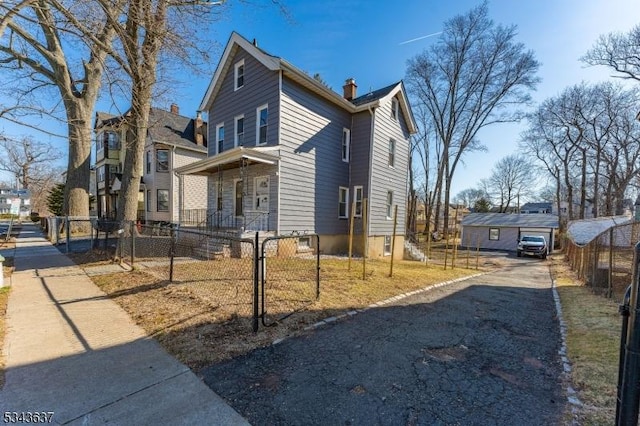 view of front of house with a fenced front yard and a chimney