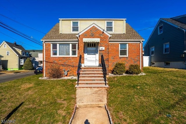 bungalow-style home with brick siding, a shingled roof, and a front yard