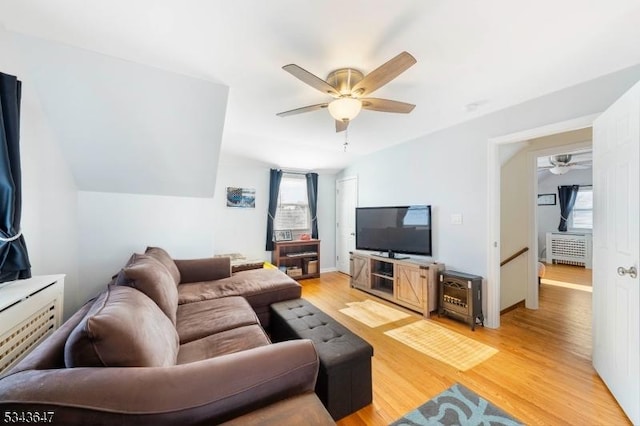 living room with a ceiling fan, light wood-style floors, and a wealth of natural light