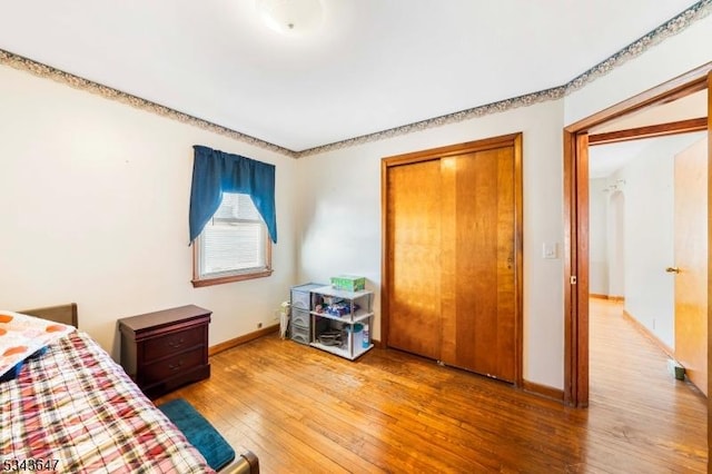 unfurnished bedroom featuring baseboards and hardwood / wood-style floors