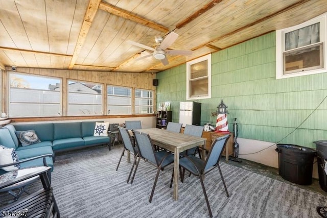 sunroom / solarium featuring wooden ceiling and a ceiling fan