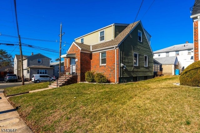 bungalow-style house featuring a front yard and brick siding