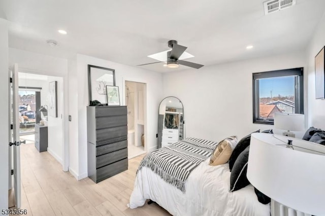 bedroom featuring visible vents, baseboards, light wood-style flooring, recessed lighting, and multiple windows