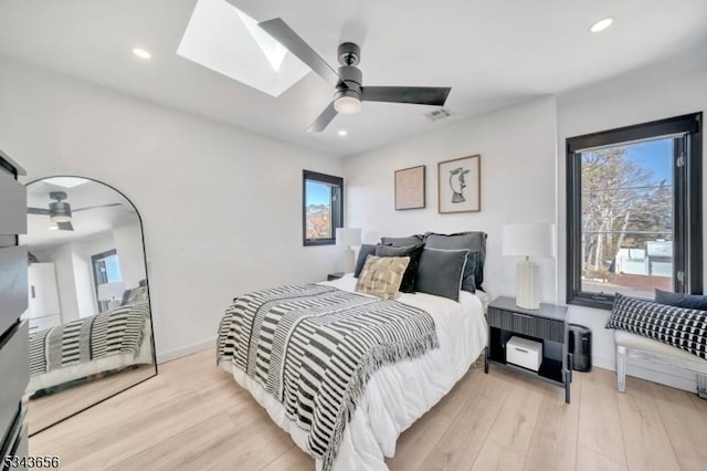 bedroom featuring a skylight, recessed lighting, and light wood finished floors