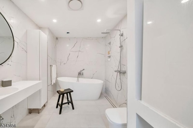 bathroom featuring a marble finish shower, toilet, recessed lighting, a soaking tub, and stone wall