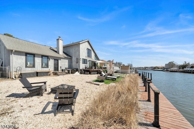 exterior space with a boat dock and a water view