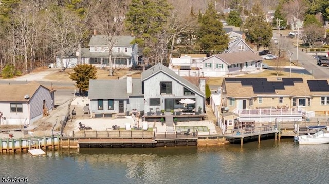 rear view of property featuring a residential view and a water view