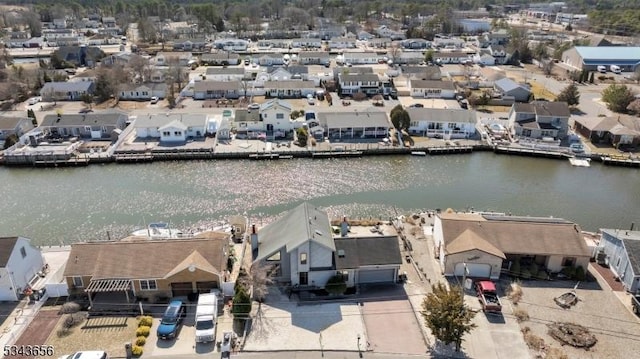 drone / aerial view featuring a residential view and a water view