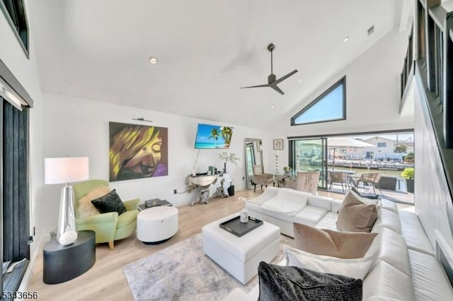 living area featuring ceiling fan, recessed lighting, wood finished floors, and high vaulted ceiling