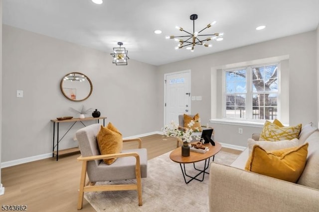 living area with recessed lighting, light wood-style floors, and baseboards