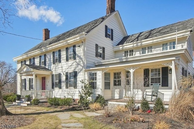 colonial-style house with a porch and a chimney