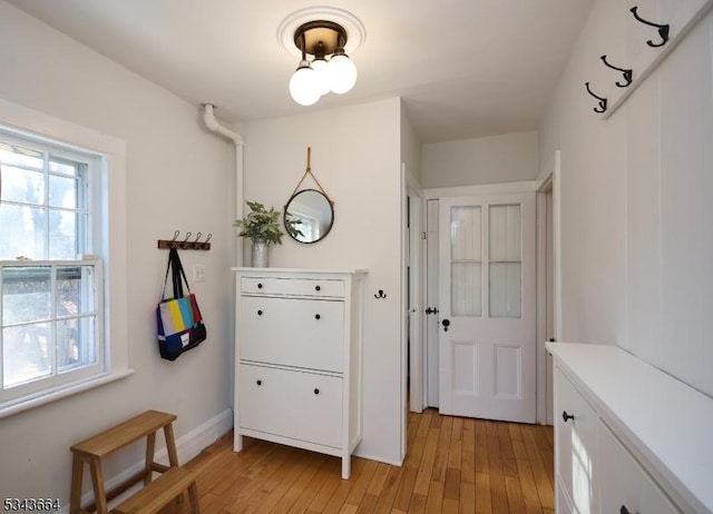 interior space with baseboards and light wood-type flooring