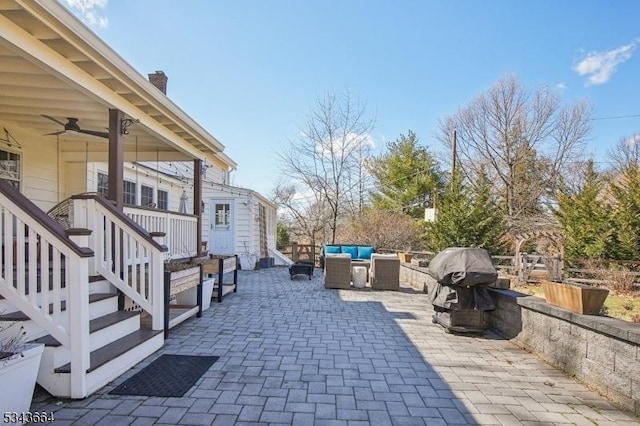 view of patio featuring an outdoor living space, a grill, and a ceiling fan