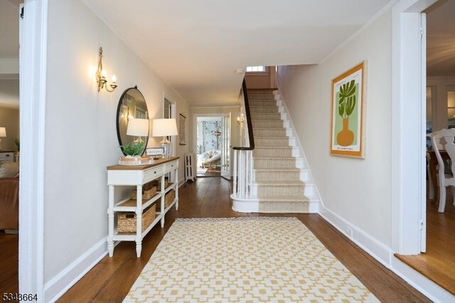 interior space featuring baseboards and wood finished floors