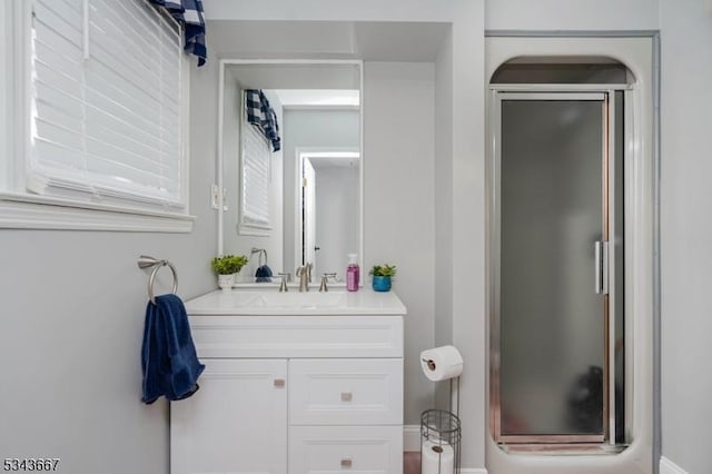 full bath featuring vanity and a shower stall