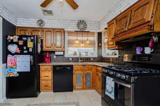 kitchen featuring visible vents, ceiling fan, a sink, black appliances, and brown cabinets