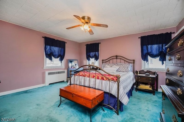 bedroom featuring radiator heating unit, baseboards, carpet floors, and ceiling fan