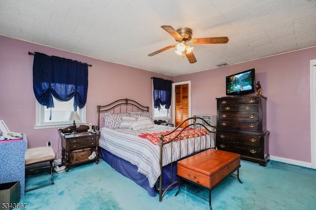 bedroom featuring visible vents, baseboards, carpet, and a ceiling fan