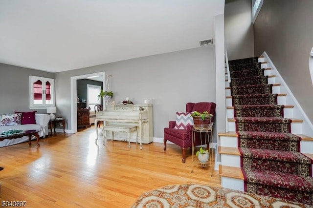 interior space with visible vents, stairs, baseboards, and wood finished floors