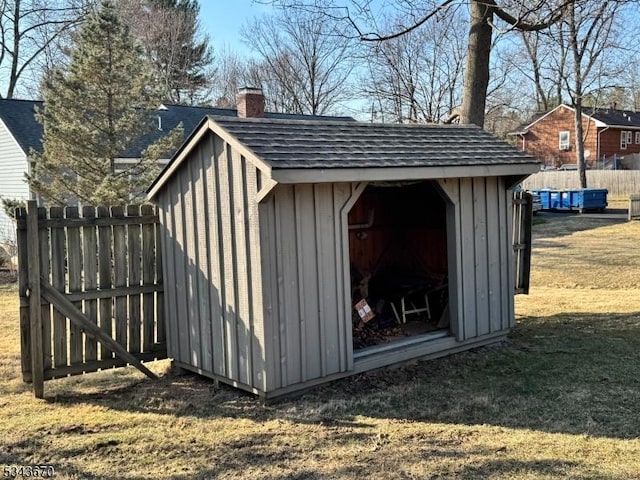 view of shed featuring fence