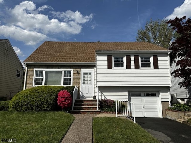131 Beverly Rd, Bloomfield Twp, NJ 07003 - view of front facade featuring an attached garage, driveway, a front yard, roof with shingles, and stone siding