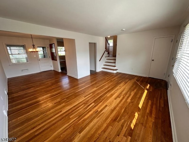 131 Beverly Rd, Bloomfield Twp, NJ 07003 - unfurnished living room with wood finished floors, a chandelier, stairs, and baseboards