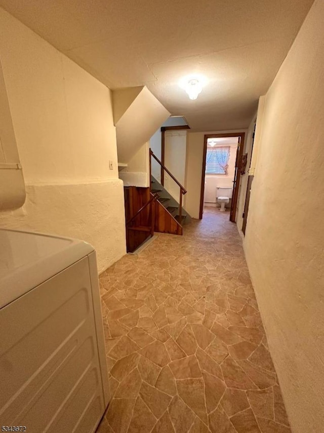 131 Beverly Rd, Bloomfield Twp, NJ 07003 - corridor with stone floors, washer / dryer, and stairs