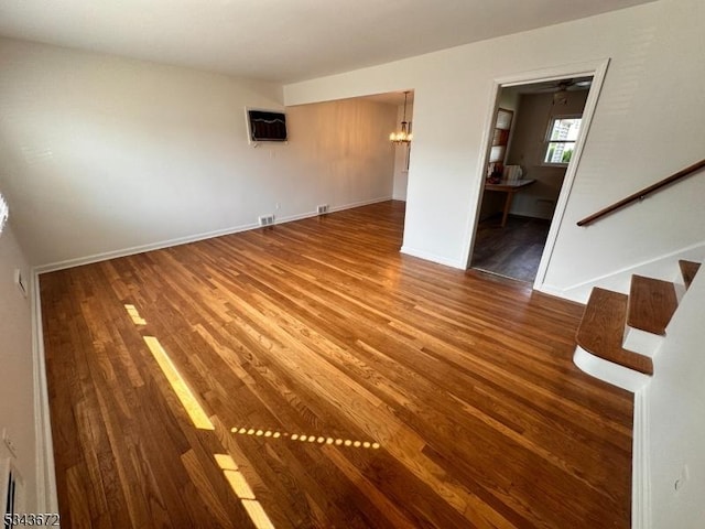 131 Beverly Rd, Bloomfield Twp, NJ 07003 - spare room with wood finished floors, stairway, baseboards, a chandelier, and a wall unit AC