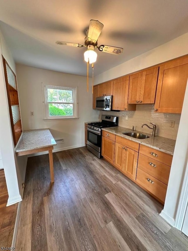 131 Beverly Rd, Bloomfield Twp, NJ 07003 - kitchen with stainless steel appliances, a sink, and brown cabinets