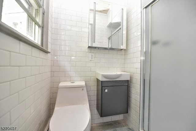 full bath featuring vanity, tile walls, toilet, and a stall shower